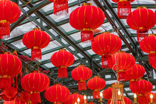 Red lanterns in large numbers decorate the street in rows. Chinese paper lantern. Chinese New Year. Traditional red Chinese lanterns on the streets. National Chinese New Year decorations.