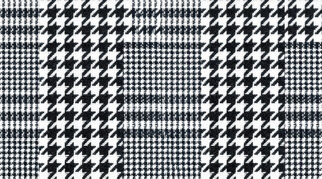 Classic black and white houndstooth plaid fabric texture for elegant fashion textile background and apparel design.