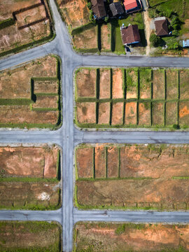 Aerial view of a residential development site with paved roads and cleared land plots in Jaragua do Sul, Santa Catarina, Brazil.