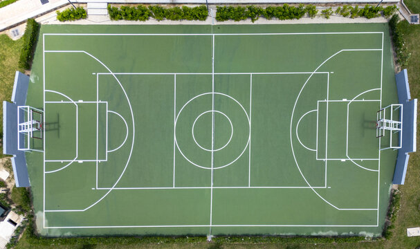 Aerial view of a green basketball court with white markings and hoops in Merida, Yucatan, Mexico.