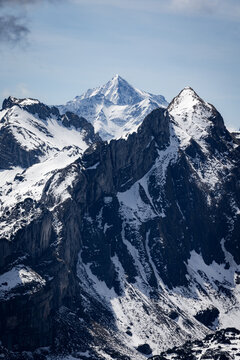View of Stoos mountain peaks covered in snow with rugged rock formations under a clear blue sky in Schwyz, Schwyz, Switzerland.