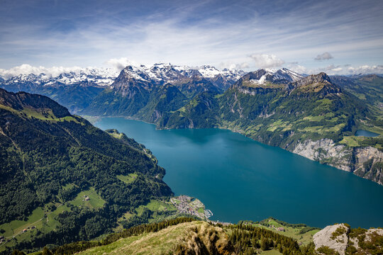 View of the Stoos area overlooking Lake Lucerne surrounded by the Swiss Alps with lush green slopes and snow-capped peaks in Schwyz, Schwyz, Switzerland.