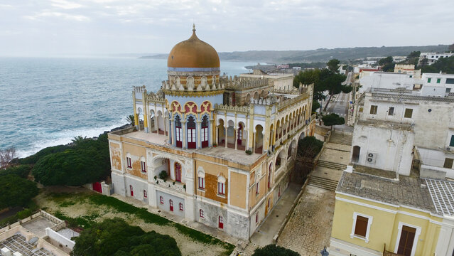 Aerial view of Palazzo Sticchi with its distinctive dome and Moorish architecture overlooking the Adriatic Sea in Santa Cesarea Terme, Puglia, Italy.