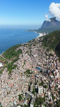 Aerial view of the dense hillside favela community overlooking the Atlantic Ocean in Rio de Janeiro, State of Rio de Janeiro, Brazil.