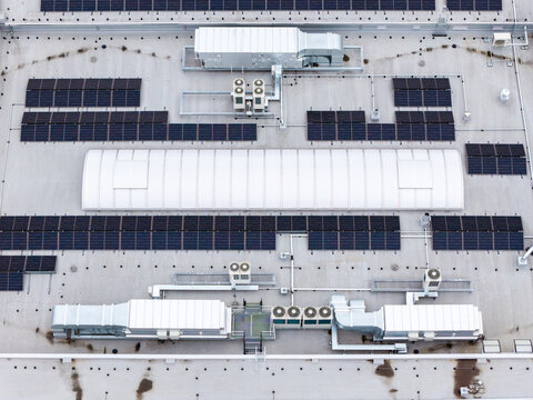 Aerial view of CH Targowek rooftop featuring solar panels, HVAC units, and a central skylight in Warsaw, Masovian Voivodeship, Poland.