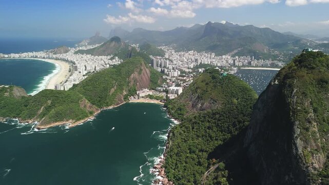 Aerial view of Sugarloaf Mountain overlooking the coastline, urban landscape, and Guanabara Bay in Rio de Janeiro, Rio de Janeiro, Brazil.