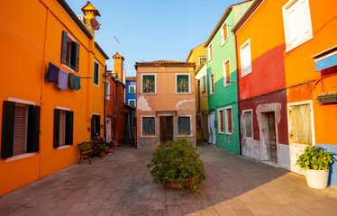Fototapeta premium Colorful houses vibrant street view with paved courtyard in Burano island Venice Italy daylight architecture landmark scene