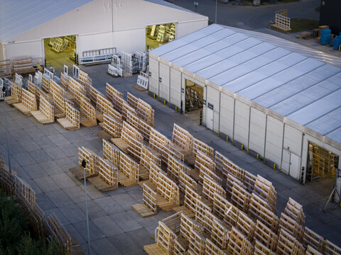 Aerial view of rows of wooden storage racks holding glass panels outside industrial warehouse buildings in Krakow, Lesser Poland Voivode, Poland.