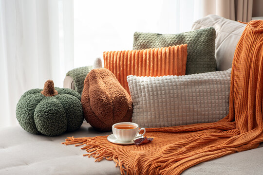 Cozy Autumn Still Life Scene With Pumpkin Pillows Warm Blanket and Tea