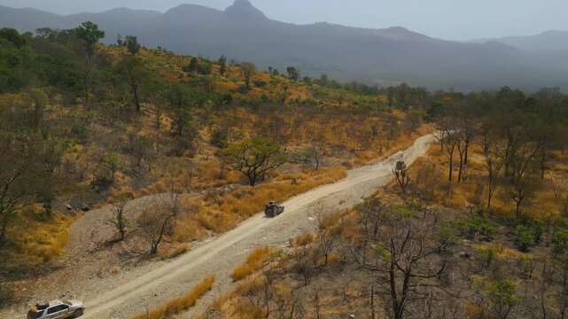 Landscape Reveal Orbit Drone Shot with 4x4 Cars in Africa
