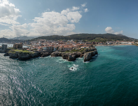 Aerial view of the historic coastal town of Castro Urdiales, featuring traditional architecture, rocky cliffs, and the blue waters of the Bay of Biscay, Castro Urdiales, Cantabria, Spain.