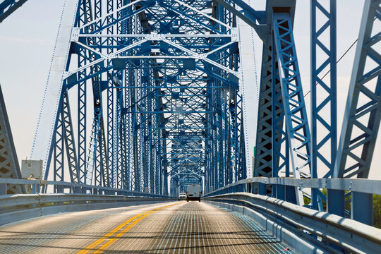 The narrow, blue-painted superstructure and deck of the U.S. 45 Ohio River Bridge, known as the Brookport Bridge or Irvin S. Cobb Bridge, connecting Paducah, Kentucky, to Brookport Illinois.