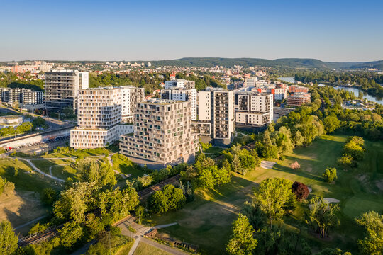 Aerial view of real modern buildings surrounded by city and nature. Residential place in the suburban area.