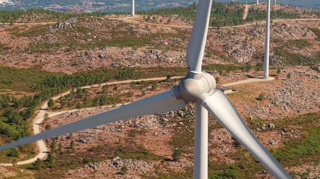Wind turbine rotor above rugged mountain terrain