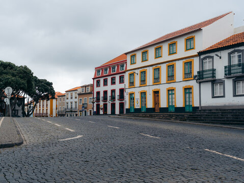 View of the historic cobblestone streets and colorful colonial architecture in the center of Angra do Heroismo, Azores, Portugal.