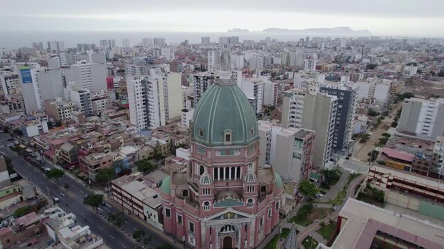Aerial view of the Inmaculado Corazon de Maria church surrounded by urban buildings and streets in Magdalena del Mar, Lima Province, Peru.