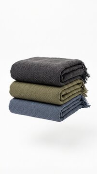 Three folded woven blankets in grey, green, and blue stacked vertically. Minimalist home decor style offering a cozy and organized feeling. Ideal for interior design or retail catalogs.