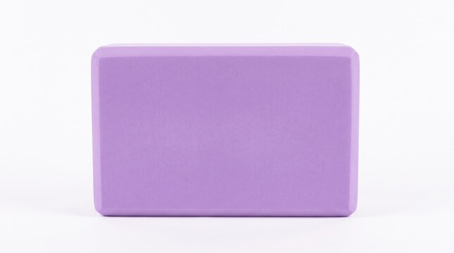 A single purple foam yoga block centered on a white background. Minimalist and clean fitness equipment. Ideal for sports retail, yoga tutorials, or healthy lifestyle articles.