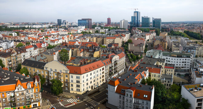Aerial view of the historic city center of Poznan with dense urban fabric, traditional red-tiled rooftops, and modern skyscrapers in the background, Poznan, Greater Poland Voivod, Poland.
