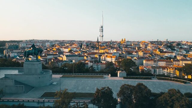 Aerial view of Zizkov Television Tower and the Jan Zizka statue on Vitkov Hill overlooking the historic city rooftops of Hlavni mesto Praha, Hlavni mesto Praha, Czechia.