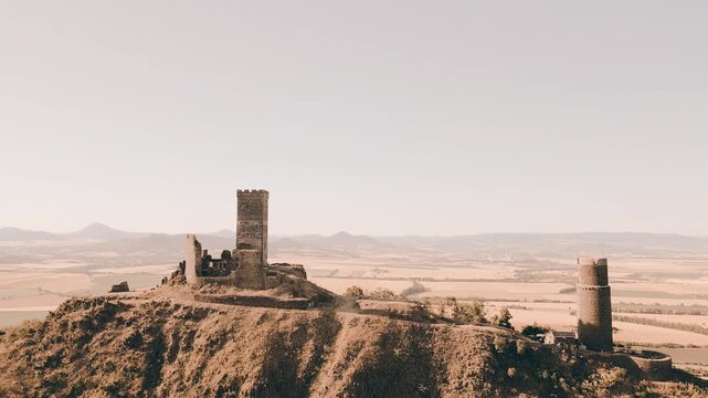 Aerial view of the medieval ruins of Hazmburk castle perched on a rocky hill overlooking the surrounding countryside in Klapy, Usti nad Labem Region, Czechia.