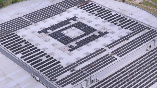 Aerial view of a large industrial rooftop covered with rows of solar panels in Gdansk, Pomeranian Voivodeship, Poland.
