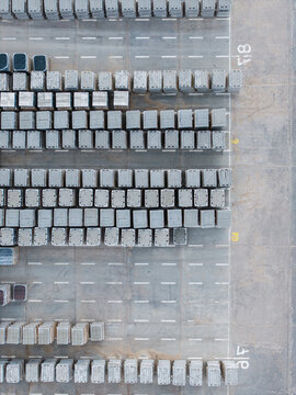 Aerial view of stacks of concrete paving stones and construction materials arranged in rows at a manufacturing facility in Riga, Latvia.