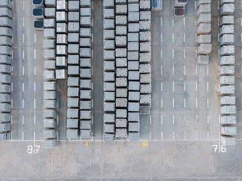 Aerial view of organized rows of stacked concrete paving stones and pavement slabs in a manufacturing yard in Riga, Latvia.