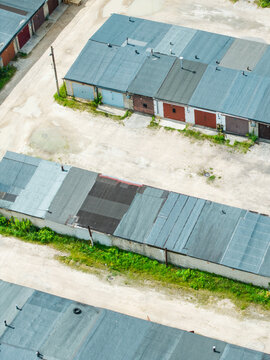 Aerial view of rows of garage units with flat roofs and metal doors in an urban area in Riga, Latvia.