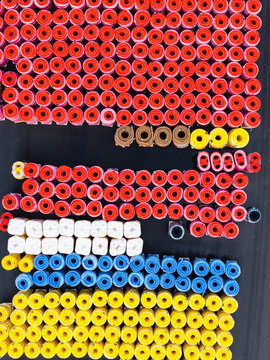Aerial view of colorful rolls of polymer pipes stored in rows at a manufacturing facility in Jelgava, Latvia.