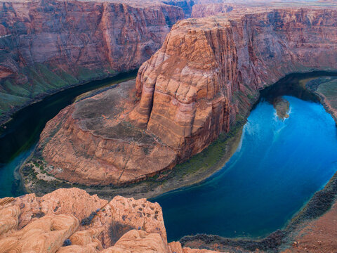 Aerial view of Horseshoe Bend with the Colorado River winding through the deep sandstone canyon walls in Coconino County, Arizona, United States.