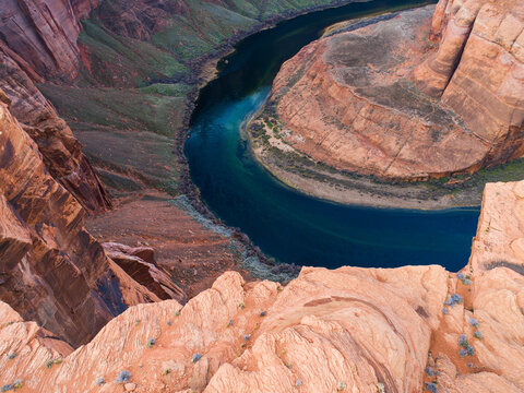 Aerial view of Horseshoe Bend with the Colorado River carving through deep sandstone cliffs in Coconino County, Arizona, United States.