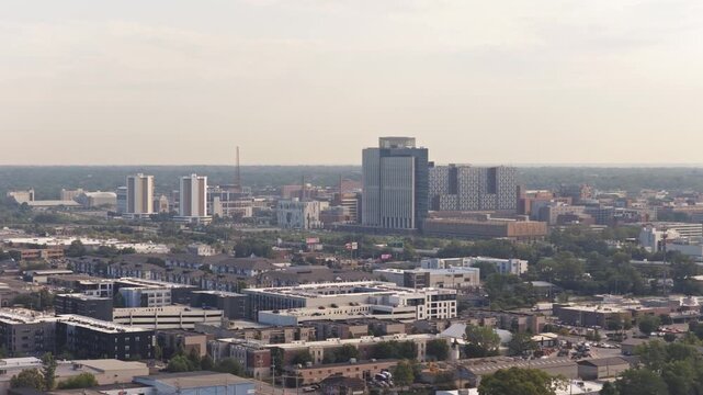 Columbus, Ohio - United States - August 3 2026: Drone aeriel from far away pushing in on OSU Ohio State University campus with dorms, high-rises, hospital, buildings, interstate 315 traffic, and roads