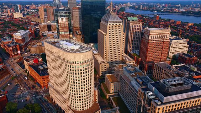 Iconic triangular-shaped office skyscraper, the Liberty Mutual Tower from drone footage. Scenery of Berkeley Street in the Back Bay neighborhood of Boston, Massachusetts at sunset time.