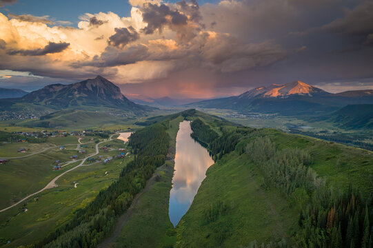 Meridian Lake also known as Long Lake reflects stormy summer clouds near Crested Butte Mountain