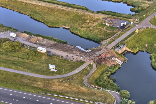 Den Oever, Noord-Holland, Netherlands - 19 June 2026: Aerial view of the Stontelerkeersluis, a sluice with a new fish passage, construction equipment, and earthworks in the landscape.