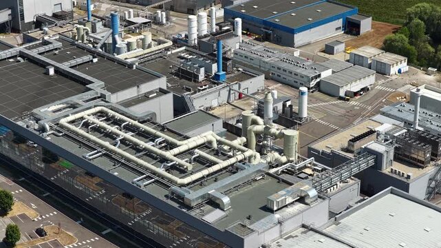 Bernin, Isere - France - August 1 2026: Aerial view of the Soitec semiconductor manufacturing facility showing extensive rooftop piping, ventilation systems and industrial production infrastructure