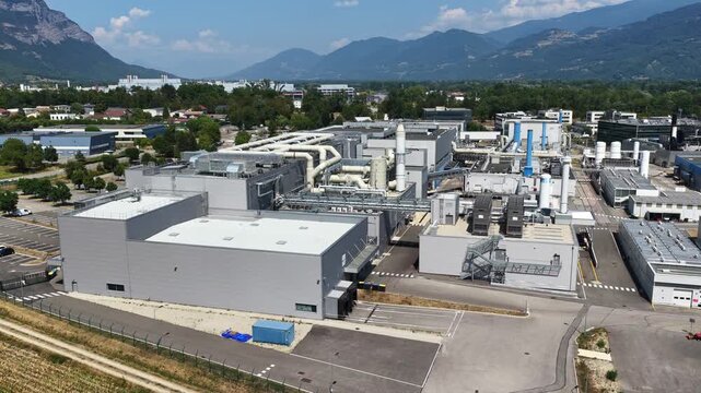 Bernin, Isere -  France - August 1 2026: Aerial view of the Soitec semiconductor manufacturing facility showing extensive rooftop piping, ventilation systems and industrial production infrastructure
