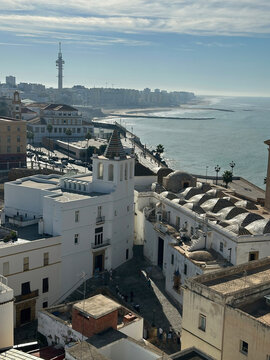View of the historic center of Cadiz with its distinctive white buildings, tiled domes, and coastal promenade overlooking the Atlantic Ocean in Cadiz, Andalusia, Spain.