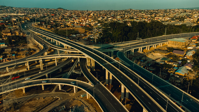 Aerial view of the Pokuase Interchange, a multi-level highway junction with concrete overpasses and ramps, surrounded by urban development in Ga North Municipal, Greater Accra Region, Ghana.