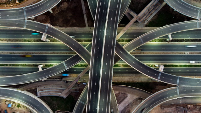 Aerial view of the Pokuase Interchange, a major multi-level road junction with sweeping flyovers, concrete lanes, and traffic flow in Ga North Municipal, Greater Accra Region, Ghana.