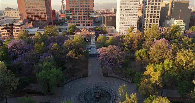 Aerial view of Alameda Central surrounded by lush trees and urban buildings in Ciudad de Mexico, Ciudad de Mexico, Mexico.