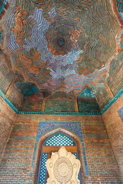 View of the intricate brickwork and blue tile patterns inside a tomb at the historic Makli Necropolis in Thatta, Sindh, Pakistan.