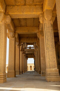 View of the intricately carved stone columns and historic arches of the Makli Necropolis in Thatta, Sindh, Pakistan.