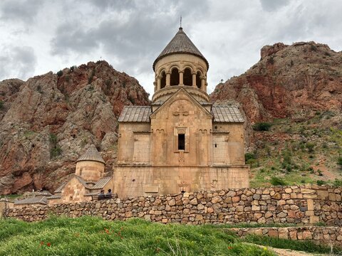 Novarank old monastery with red rocks on the background , Armenia 