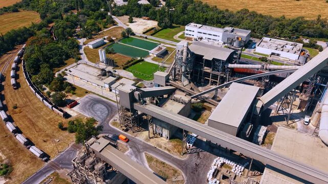 Footage over the facility of a modern cement manufacturing plant. Modern industrial area in the countryside.