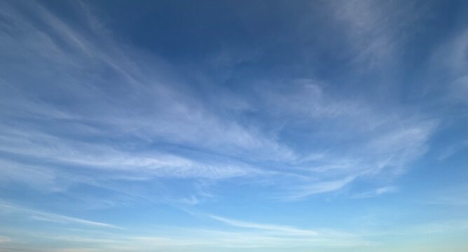 Blue sky with sweeping wispy clouds and soft natural background
