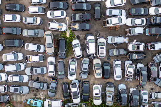 Aerial view of cars junk yard with rows of parked and salvaged vehicles in an outdoor lot in Petah Tikva, Center District, Israel.
