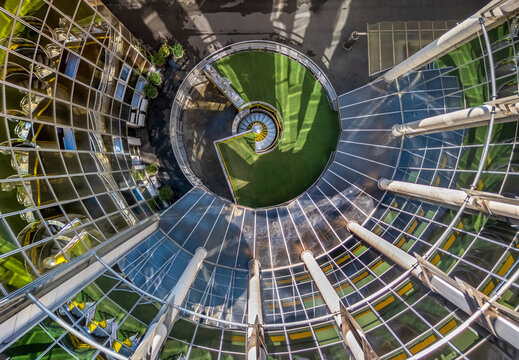 Aerial view of a modern glass building featuring a circular courtyard with a spiral staircase and green space in Belgrade, City of Belgrade, Serbia.