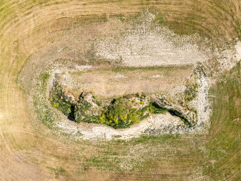 Aerial view of the Dijk van een wijf earthwork structure surrounded by agricultural fields in Oosterbierum, Friesland, Netherlands.